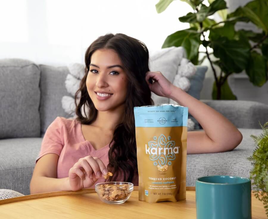 a woman eating toasted cashews