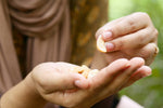 woman eating cashew nuts